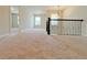 Upstairs hallway featuring plush carpeting, natural lighting, and decorative railing at 1264 Brynhill Ct, Buford, GA 30518