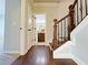 Hallway featuring hardwood floors and staircase with wrought iron railings at 1264 Brynhill Ct, Buford, GA 30518
