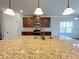 Kitchen island with a sink and granite countertop at 1264 Brynhill Ct, Buford, GA 30518
