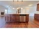 Spacious kitchen island with stainless steel dishwasher and pendant lighting at 1264 Brynhill Ct, Buford, GA 30518
