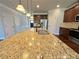 Kitchen island with a sink, granite countertop, and stainless steel appliances at 1264 Brynhill Ct, Buford, GA 30518