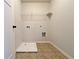 Laundry room with tile flooring, shelving, and hookups for washer and dryer at 1264 Brynhill Ct, Buford, GA 30518