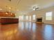 Open concept living room with a fireplace, hardwood floors, and lots of natural light at 1264 Brynhill Ct, Buford, GA 30518