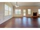 Bright living room with hardwood floors, wainscoting, a fireplace, and multiple windows at 1264 Brynhill Ct, Buford, GA 30518