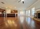 Open-concept living room featuring a kitchen, fireplace, and hardwood floors at 1264 Brynhill Ct, Buford, GA 30518