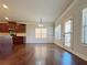 Living room with hardwood floors, wainscoting, and a large window at 1264 Brynhill Ct, Buford, GA 30518