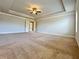 Spacious main bedroom featuring neutral tones, tray ceiling, ceiling fan, and plush carpet at 1264 Brynhill Ct, Buford, GA 30518