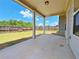 Spacious covered patio overlooking a large fenced backyard with green grass at 1264 Brynhill Ct, Buford, GA 30518