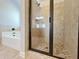 Glass enclosed shower showcasing a decorative tiled surround and tiled floor in the bathroom at 1264 Brynhill Ct, Buford, GA 30518