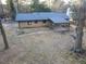 Backyard featuring a covered patio, mature trees, and bare landscaping at 4011 Lake Carlton Rd, Loganville, GA 30052