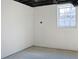 Unfinished basement featuring white walls and window, offering renovation potential at 4011 Lake Carlton Rd, Loganville, GA 30052