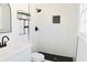 Renovated bathroom featuring a sleek vanity and black accents on the shower and fixtures at 4011 Lake Carlton Rd, Loganville, GA 30052