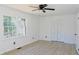 Bright bedroom features wood laminate flooring, windows, and a closet with folding doors at 4011 Lake Carlton Rd, Loganville, GA 30052