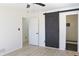 Bedroom with a large sliding black barn door leading to the bathroom at 4011 Lake Carlton Rd, Loganville, GA 30052