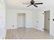 Bright bedroom with light wood flooring, a window, and a closet with bifold doors at 4011 Lake Carlton Rd, Loganville, GA 30052