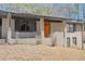 Charming single-Gathering home featuring an inviting front porch and bright orange front door at 4011 Lake Carlton Rd, Loganville, GA 30052