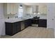 Modern kitchen featuring gray lower cabinets, white upper cabinets, and stainless steel appliances at 4011 Lake Carlton Rd, Loganville, GA 30052