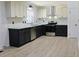 Modern kitchen featuring gray lower cabinets, white upper cabinets, and stainless steel appliances at 4011 Lake Carlton Rd, Loganville, GA 30052