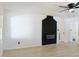 Bright living room with modern floors, and fireplace with a black brick surround at 4011 Lake Carlton Rd, Loganville, GA 30052