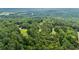 Aerial view of wooded property featuring mature trees and a home with long driveway at 4030 Grady Smith Road Rd, Loganville, GA 30052