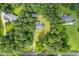 Expansive aerial view of wooded property featuring mature trees, a swimming pool, a detached garage, and multiple structures at 4030 Grady Smith Road Rd, Loganville, GA 30052