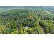 Expansive aerial view of a wooded property and home in Loganville, Georgia at 4030 Grady Smith Road Rd, Loganville, GA 30052