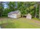 View of the home's back yard with a large yard and storage at 4030 Grady Smith Road Rd, Loganville, GA 30052