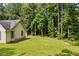Spacious backyard with mature trees, fenced-in area, and shed at 4030 Grady Smith Road Rd, Loganville, GA 30052