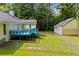 Fenced in backyard, detached garage, with a home that features a blue painted deck at 4030 Grady Smith Road Rd, Loganville, GA 30052