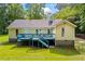 View of the house with a blue painted deck, fenced yard, and mature trees at 4030 Grady Smith Road Rd, Loganville, GA 30052