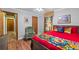 Cozy bedroom features a large red bed and views into another room at 4030 Grady Smith Road Rd, Loganville, GA 30052