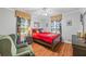 Comfortable bedroom featuring wood floors, a ceiling fan, and decorative curtains at 4030 Grady Smith Road Rd, Loganville, GA 30052