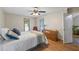 Comfortable bedroom featuring a ceiling fan, wood floors, and a wooden dresser at 4030 Grady Smith Road Rd, Loganville, GA 30052