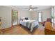 Cozy bedroom featuring a ceiling fan, wood floors, and two windows for natural light at 4030 Grady Smith Road Rd, Loganville, GA 30052