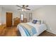 Spacious bedroom showcasing wood floors, ceiling fan, and three dressers for storage at 4030 Grady Smith Road Rd, Loganville, GA 30052