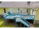 A detailed view of the blue deck with stairs and a table and chairs at 4030 Grady Smith Road Rd, Loganville, GA 30052