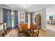 Traditional dining room with wood table and chairs and decorative curtains at 4030 Grady Smith Road Rd, Loganville, GA 30052