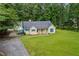 Charming single-Gathering home with a well-manicured front lawn, plus a detached garage and serene surroundings at 4030 Grady Smith Road Rd, Loganville, GA 30052