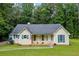 Inviting single-Gathering home featuring a manicured front lawn, complemented by charming blue shutters at 4030 Grady Smith Road Rd, Loganville, GA 30052