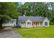 Charming single-story home with a well-maintained lawn, complemented by a detached garage and driveway at 4030 Grady Smith Road Rd, Loganville, GA 30052