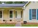 A view of the front porch with white columns and blue shutters at 4030 Grady Smith Road Rd, Loganville, GA 30052