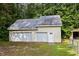 Spacious two-car garage with ample storage, featuring a convenient side door and durable metal roof at 4030 Grady Smith Road Rd, Loganville, GA 30052