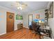 Home office with wood floors, two windows, and a rolling chair at 4030 Grady Smith Road Rd, Loganville, GA 30052
