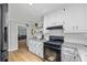 Spacious kitchen with white cabinets, granite counters, and stainless steel appliances at 4030 Grady Smith Road Rd, Loganville, GA 30052