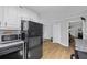Modern kitchen with white cabinets, black appliances and granite countertops at 4030 Grady Smith Road Rd, Loganville, GA 30052