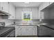 Updated kitchen with white cabinets, granite countertops, and stainless steel appliances at 4030 Grady Smith Road Rd, Loganville, GA 30052