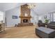 Living room features a stone fireplace, hardwood floors, and vaulted ceilings at 4030 Grady Smith Road Rd, Loganville, GA 30052
