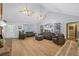 Bright living room with vaulted ceilings, hardwood flooring, and comfortable seating arrangement at 4030 Grady Smith Road Rd, Loganville, GA 30052