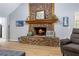 A cozy living room features a stone fireplace and hardwood floors at 4030 Grady Smith Road Rd, Loganville, GA 30052