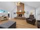 Vaulted living room with a stone fireplace, hardwood floors, TV, and a comfortable layout at 4030 Grady Smith Road Rd, Loganville, GA 30052